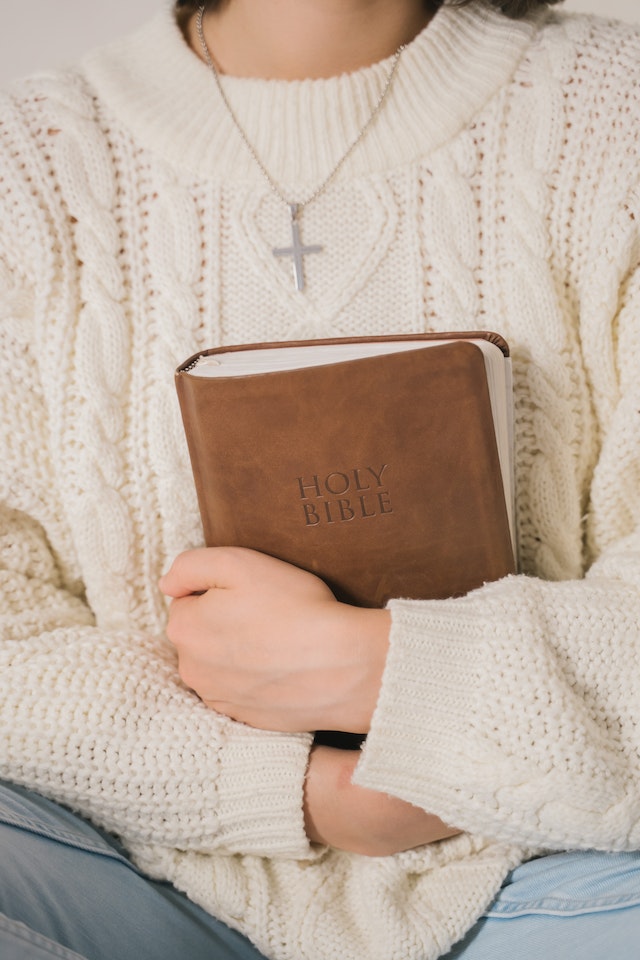 woman holding bible woman holding bible