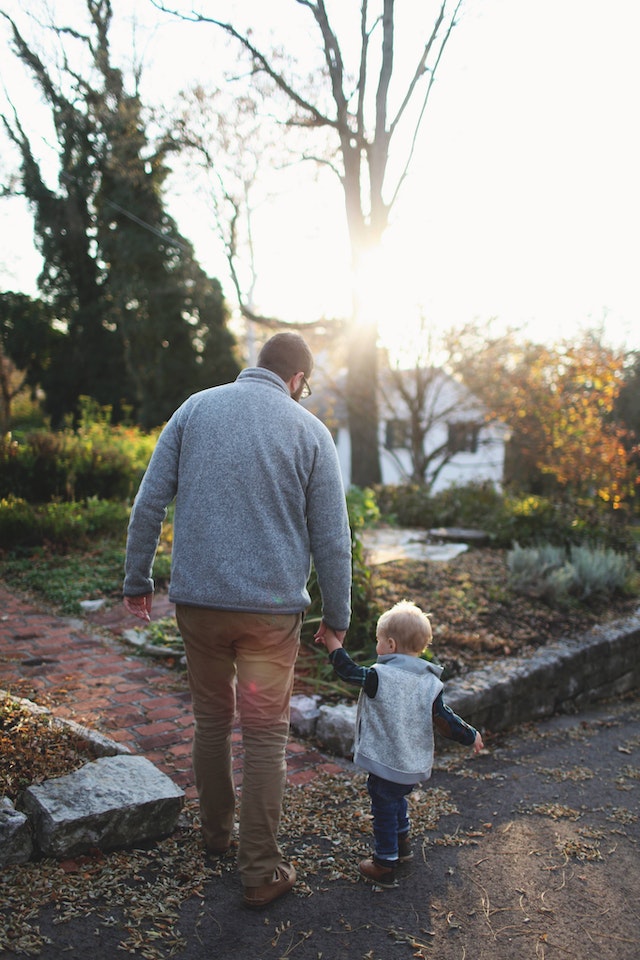 man walking with son man walking with son
