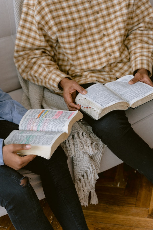 parents reading Bible with child parents reading Bible with child